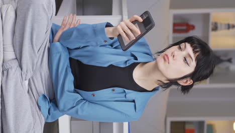 Vertical-video-of-The-young-woman-on-the-phone.